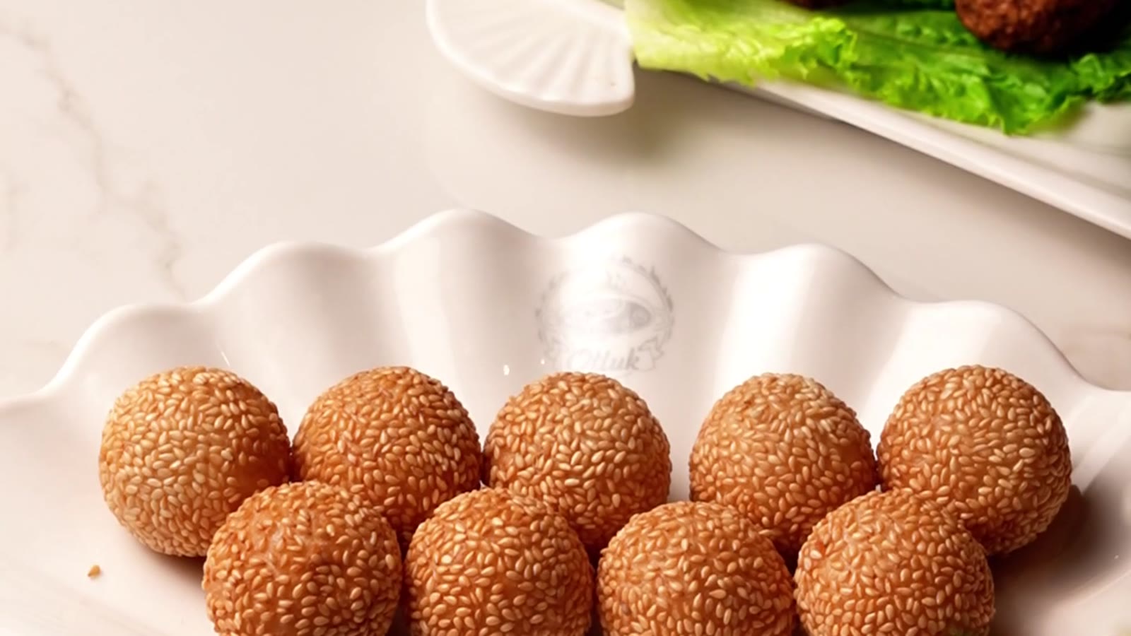 Fried sesame balls and handmade beef balls on the table at Otluk Hot Pot