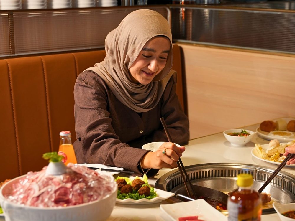 Two guests sharing an all you can eat table at Otluk Hot Pot