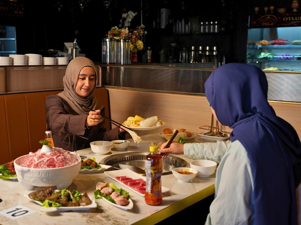 A bowl of freshly sliced halal meat on a dining table at Otluk Hot Pot