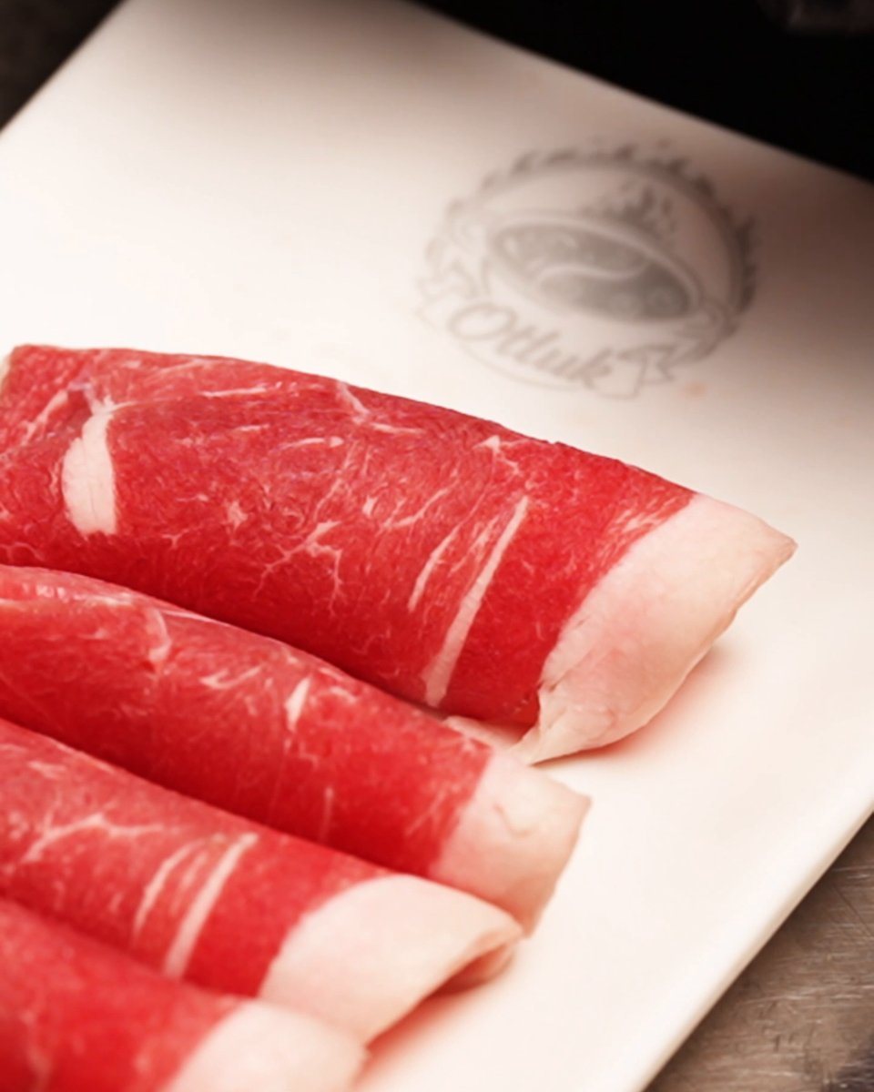 Freshly sliced halal lamb rolled on an Otluk Hot Pot plate