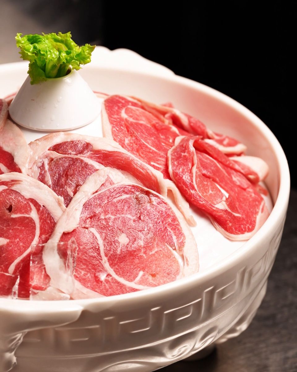 AAA premium beef slices fanned in a white bowl
