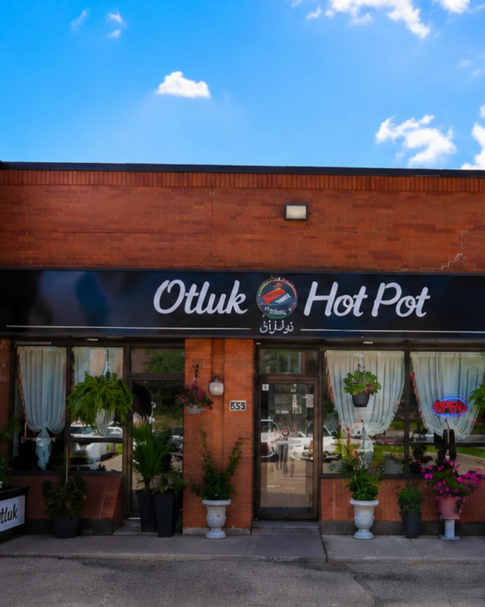 The Otluk Hot Pot sign and planters on Oakdale Road