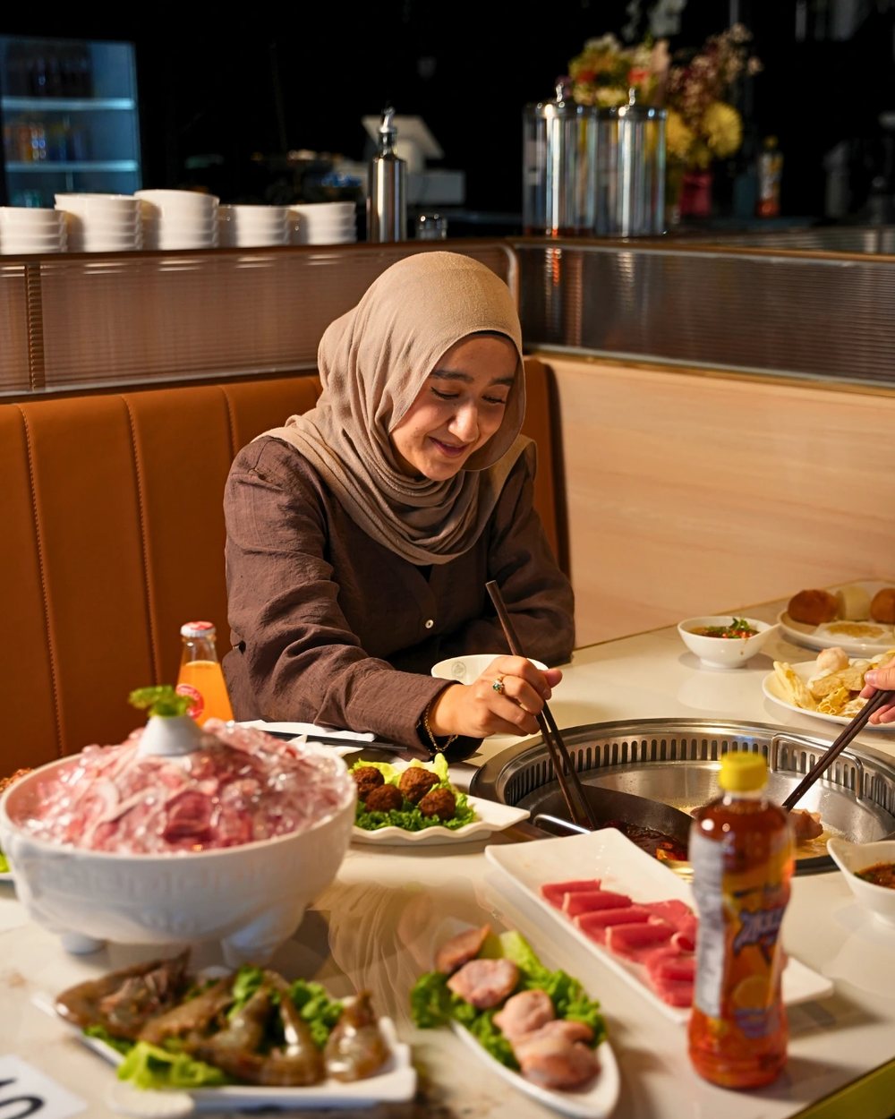 A guest building a sauce bowl at the bar