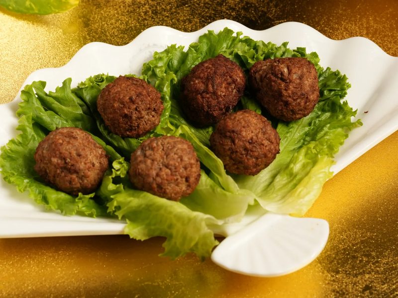 Handmade beef balls served on lettuce