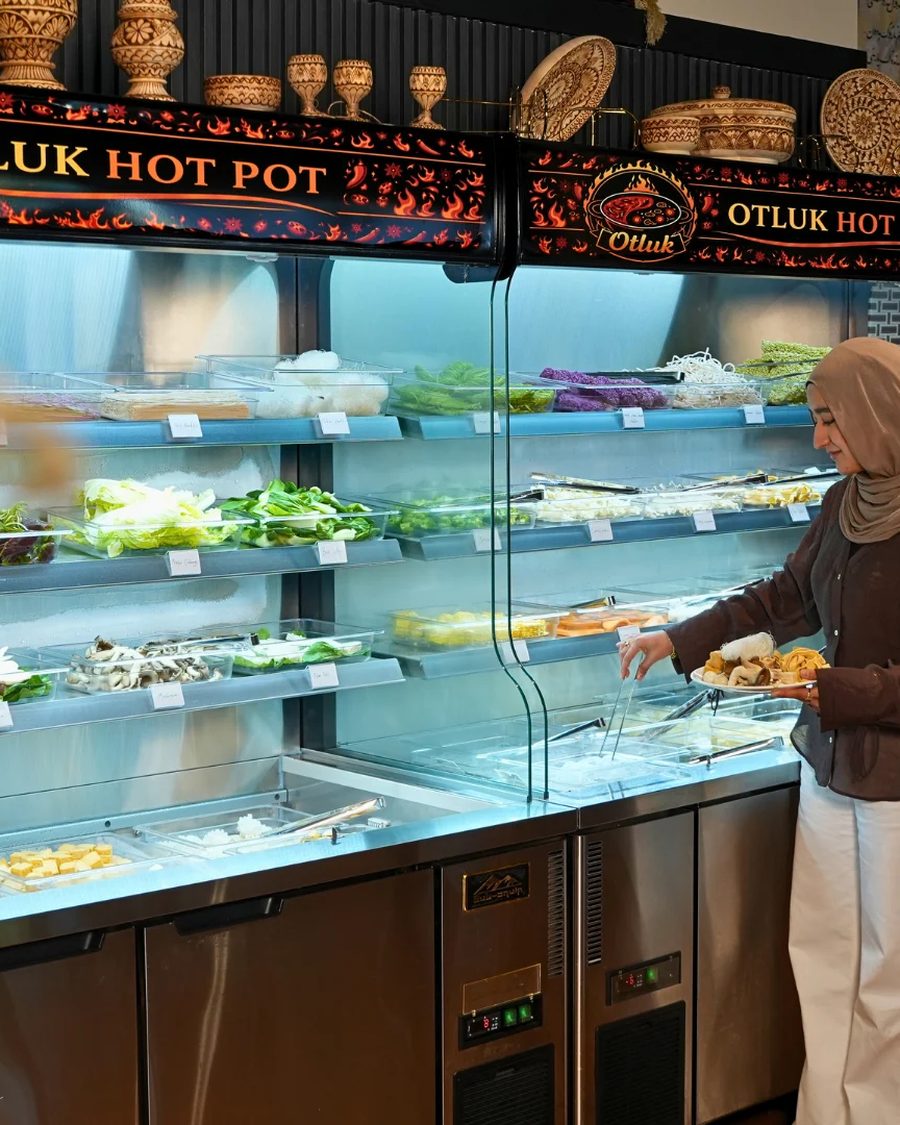 The self-serve fridge at Otluk Hot Pot stocked with fresh vegetables